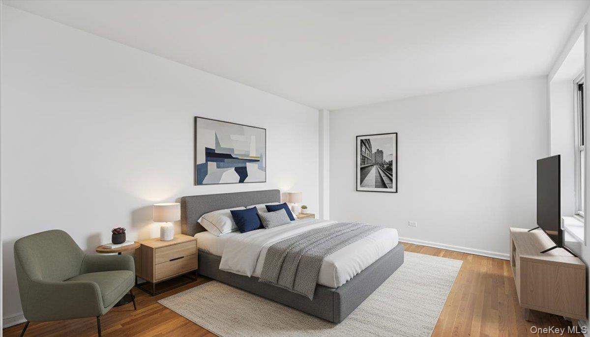 210-15 23rd Avenue, Unit 3F Queens, NY 11360 - Photo 20 of 24 a bedroom with a bed and a couch