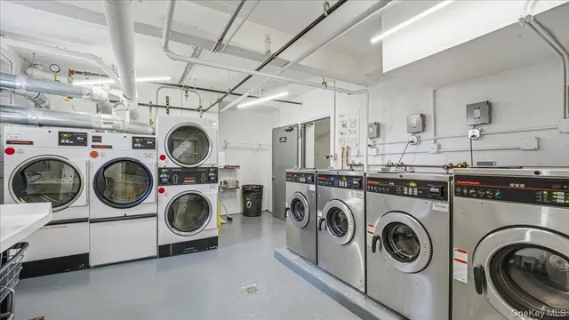 a utility room with dryer washer and sink