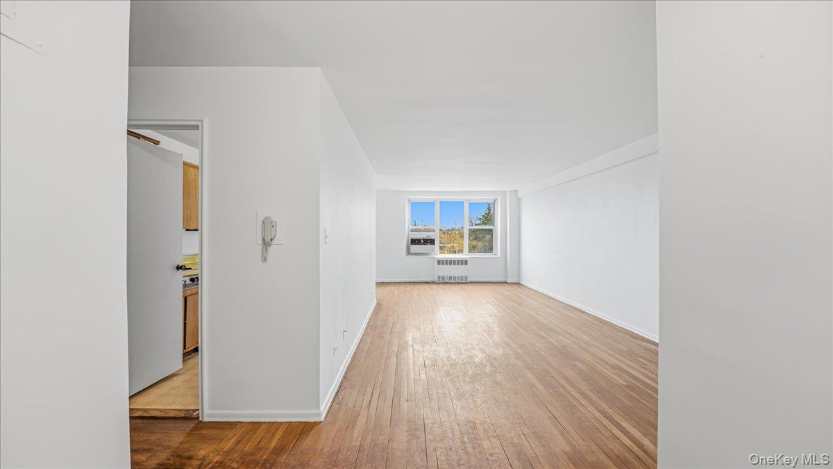 210-15 23rd Avenue, Unit 3F Queens, NY 11360 - Photo 3 of 24 a view of a room with wooden floor and a window