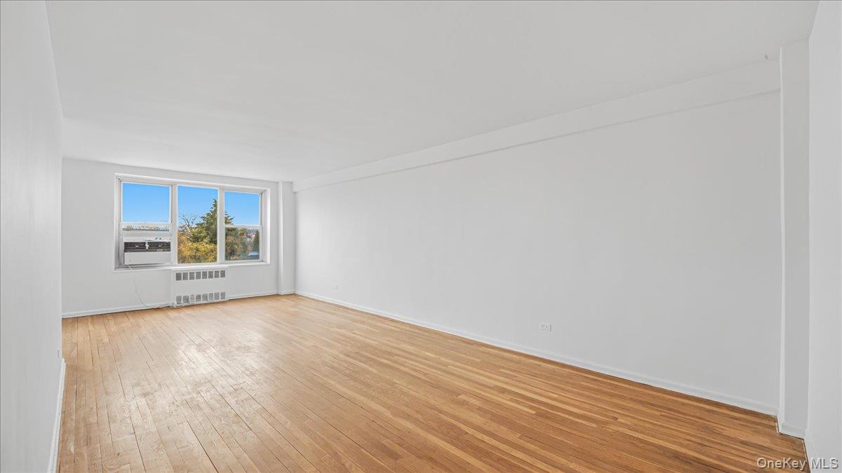 210-15 23rd Avenue, Unit 3F Queens, NY 11360 - Photo 4 of 24 a view of an empty room and window