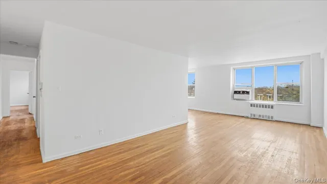 a view of a kitchen with wooden floor and a window