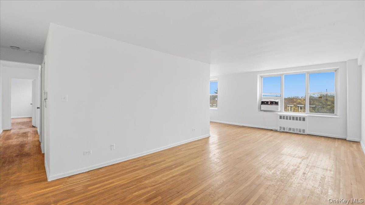 210-15 23rd Avenue, Unit 3F Queens, NY 11360 - Photo 7 of 24 a view of a kitchen with wooden floor and a window