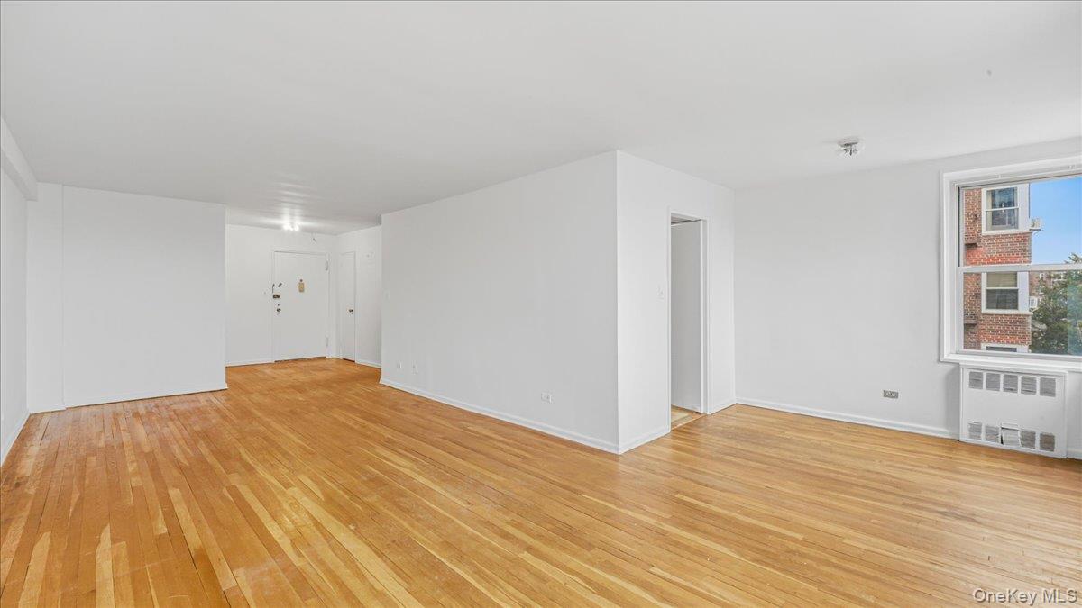 210-15 23rd Avenue, Unit 3F Queens, NY 11360 - Photo 8 of 24 a view of empty room with wooden floor