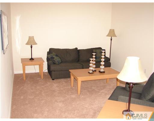 963 Clark Road North Brunswick, NJ 08902 - Photo 5 of 6 a living room with furniture and a lamp