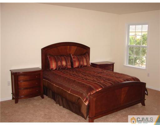 963 Clark Road North Brunswick, NJ 08902 - Photo 6 of 6 a bed sitting in a bedroom next to a window