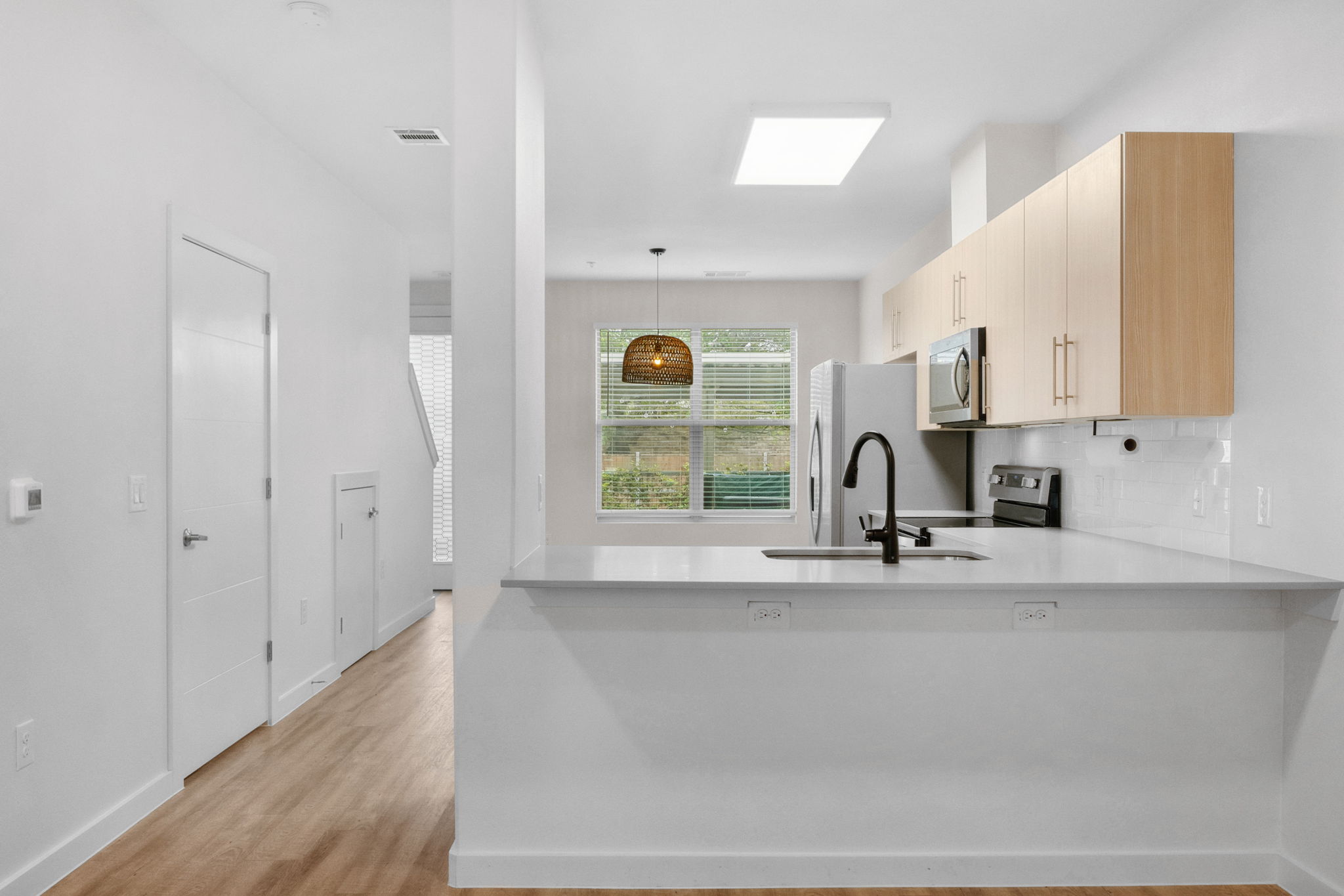 7805 Cooper Lane, Unit 606 Austin, TX 78745 - Photo 10 of 35 a view of kitchen with wooden floor and window