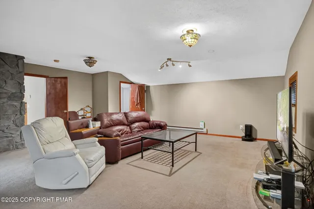 a living room with furniture and a lamp