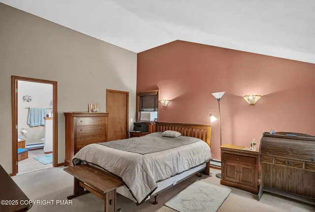 a bedroom with a bed and dresser