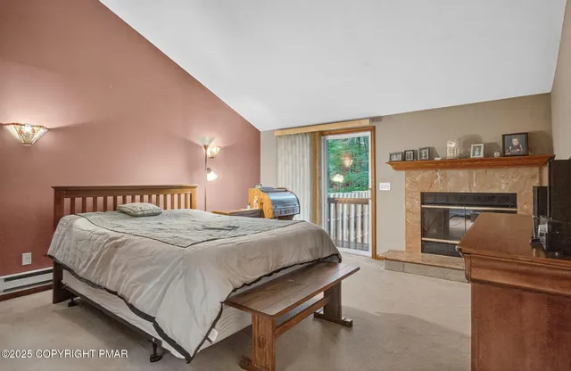 a spacious bedroom with a bed and a fireplace