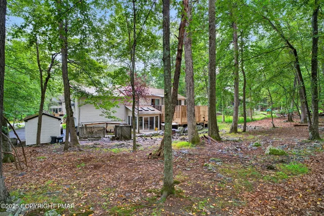 a view of outdoor space with deck and yard