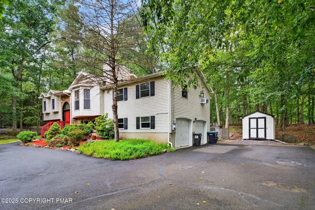 a front view of a house with a garden and plants
