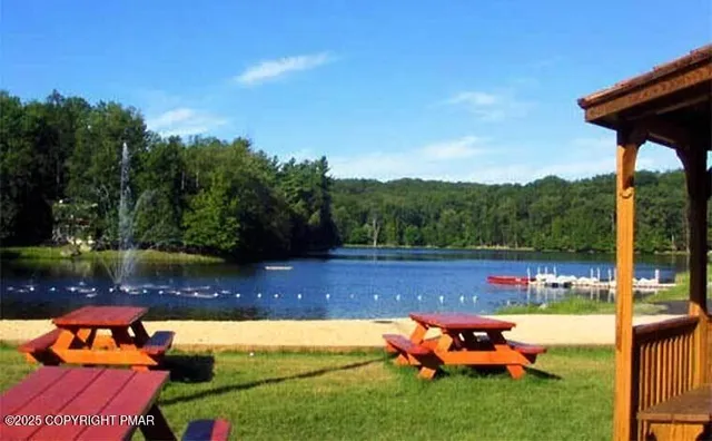 a backyard of a house with yard table and chairs