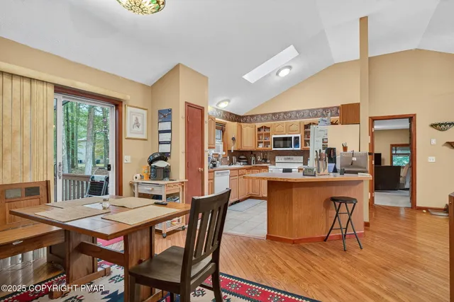 a dining table with chairs and window