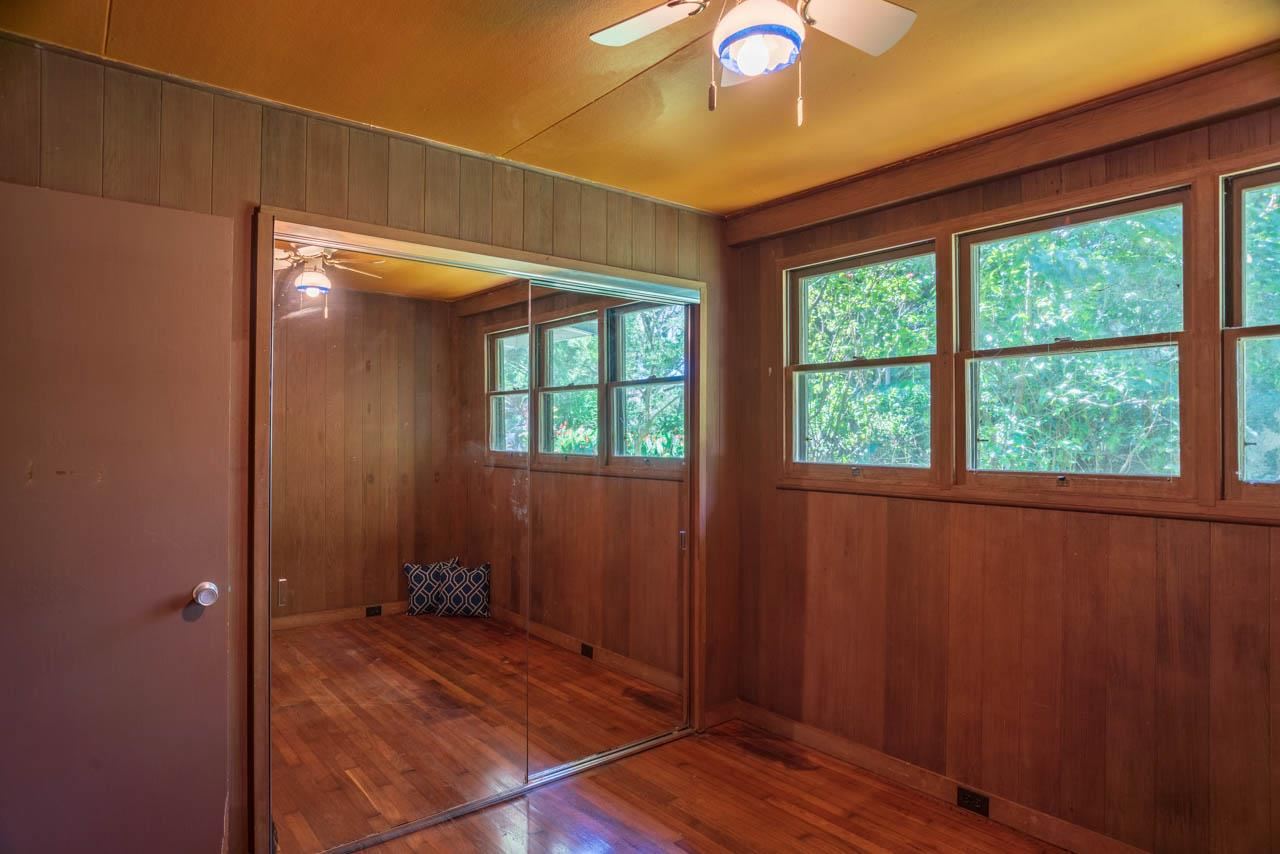 373 Ulumalu Road Haiku, HI 96708 - Photo 12 of 30 an empty room with wooden floor and windows