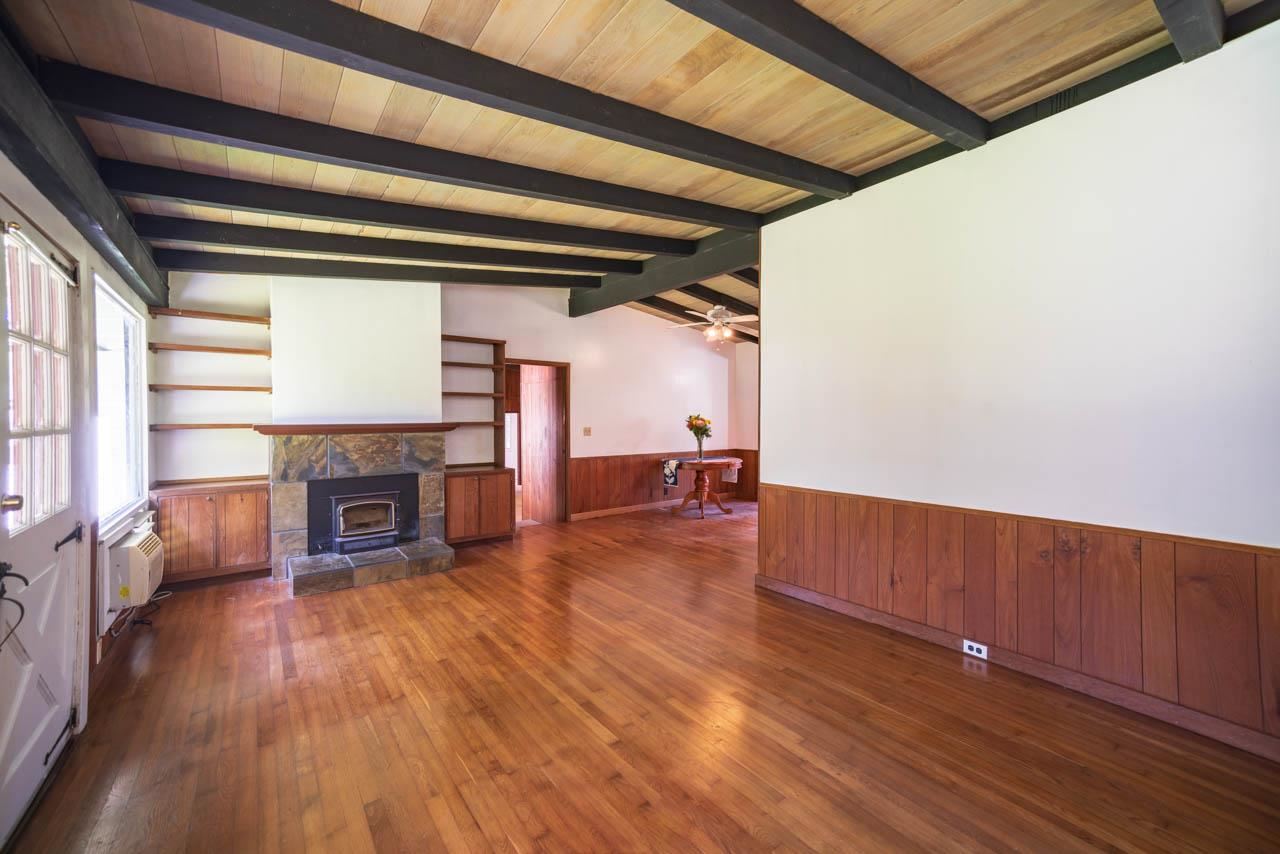 373 Ulumalu Road Haiku, HI 96708 - Photo 4 of 30 a view of a livingroom with wooden floor a fireplace and window