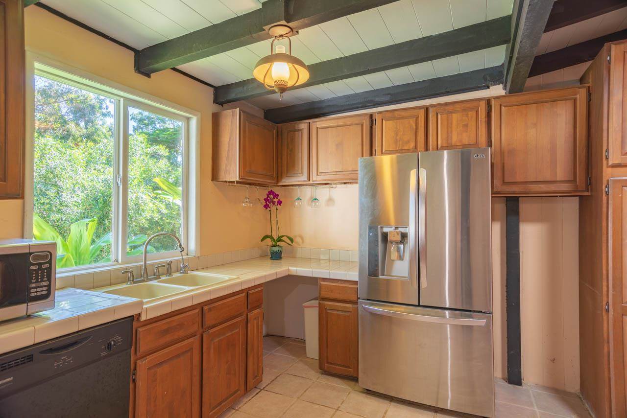 373 Ulumalu Road Haiku, HI 96708 - Photo 7 of 30 a kitchen with stainless steel appliances a refrigerator and a window