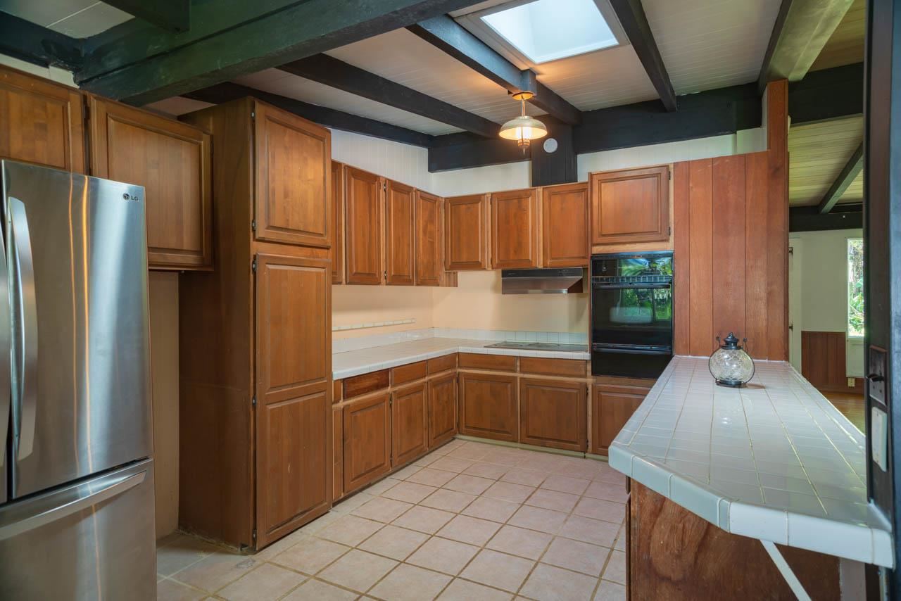 373 Ulumalu Road Haiku, HI 96708 - Photo 8 of 30 a kitchen with granite countertop a refrigerator and a sink
