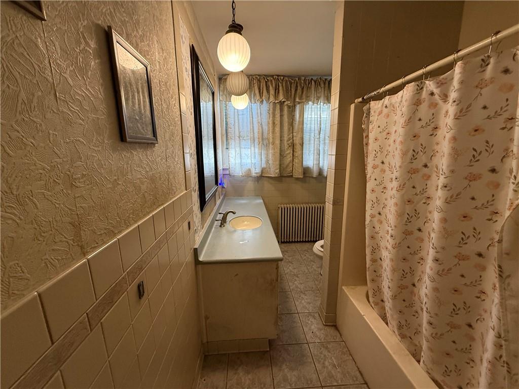 12 Connor Street Uniontown, PA 15401 - Photo 15 of 15 a bathroom with a sink a mirror and a shower