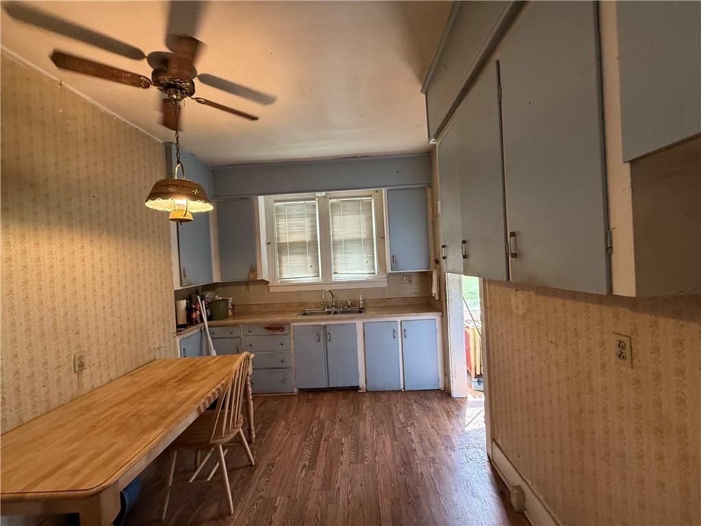 12 Connor Street Uniontown, PA 15401 - Photo 8 of 15 a kitchen with granite countertop a stove a sink dishwasher and a refrigerator with wooden floor
