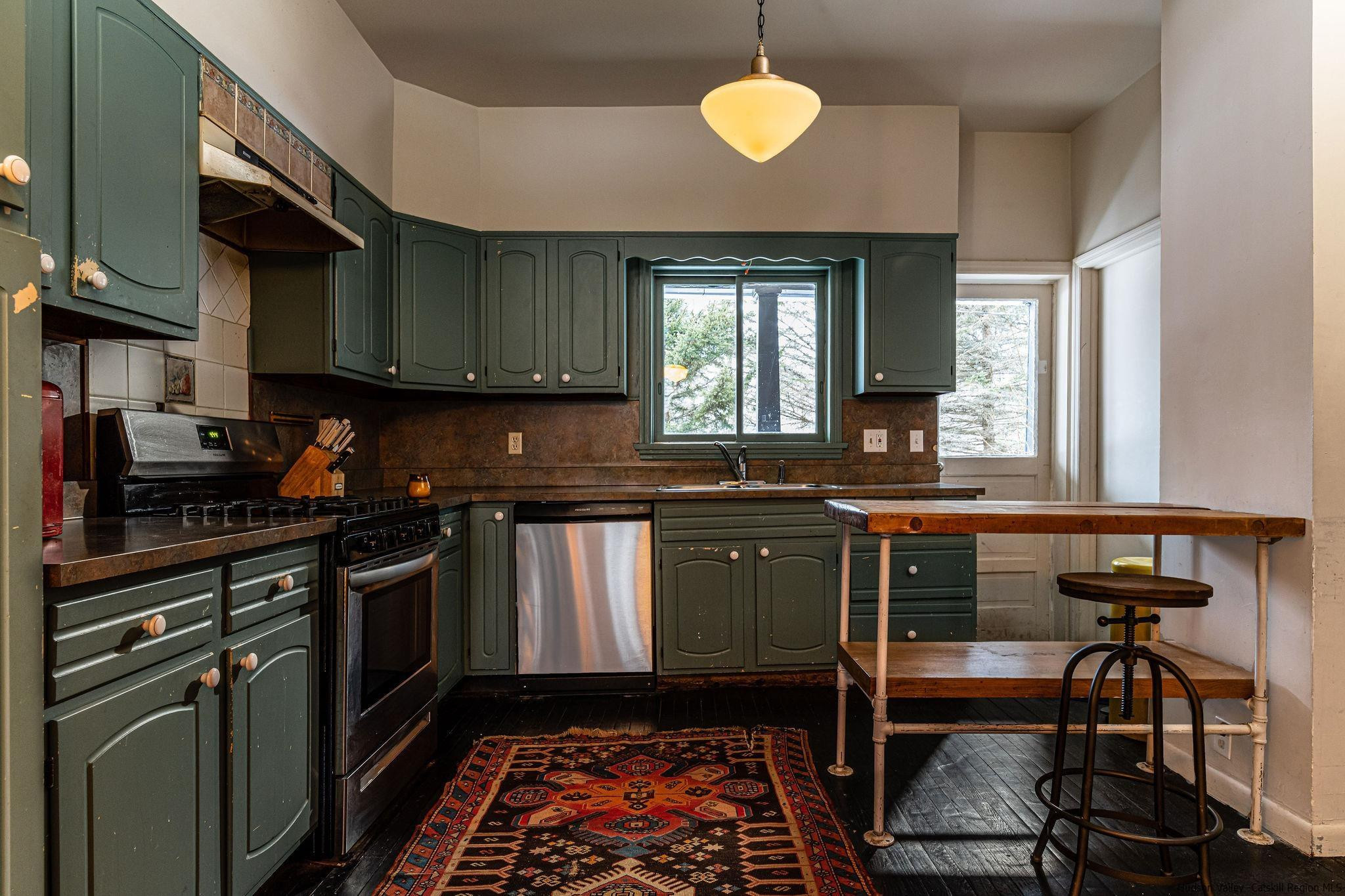 54155 Main Street Roxbury, NY 12474 - Photo 15 of 20 a kitchen with a sink stove and cabinets