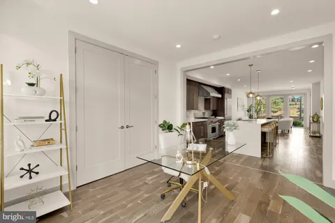 a living room with furniture and kitchen view