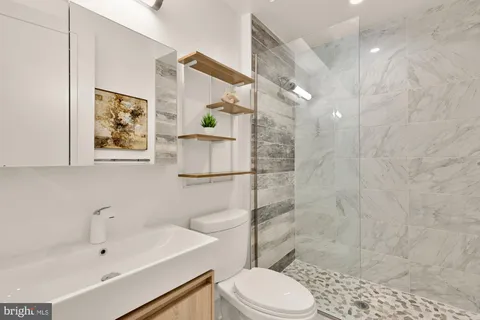 a bathroom with a sink toilet and shower