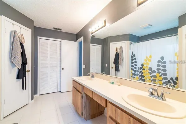 a bathroom with a double vanity sink and a mirror