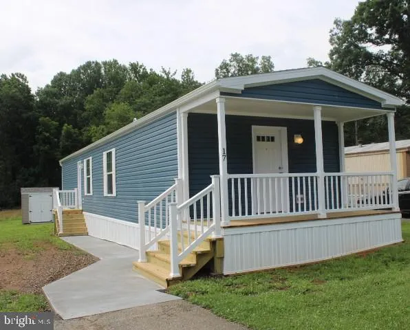 a view of a house with a yard and deck