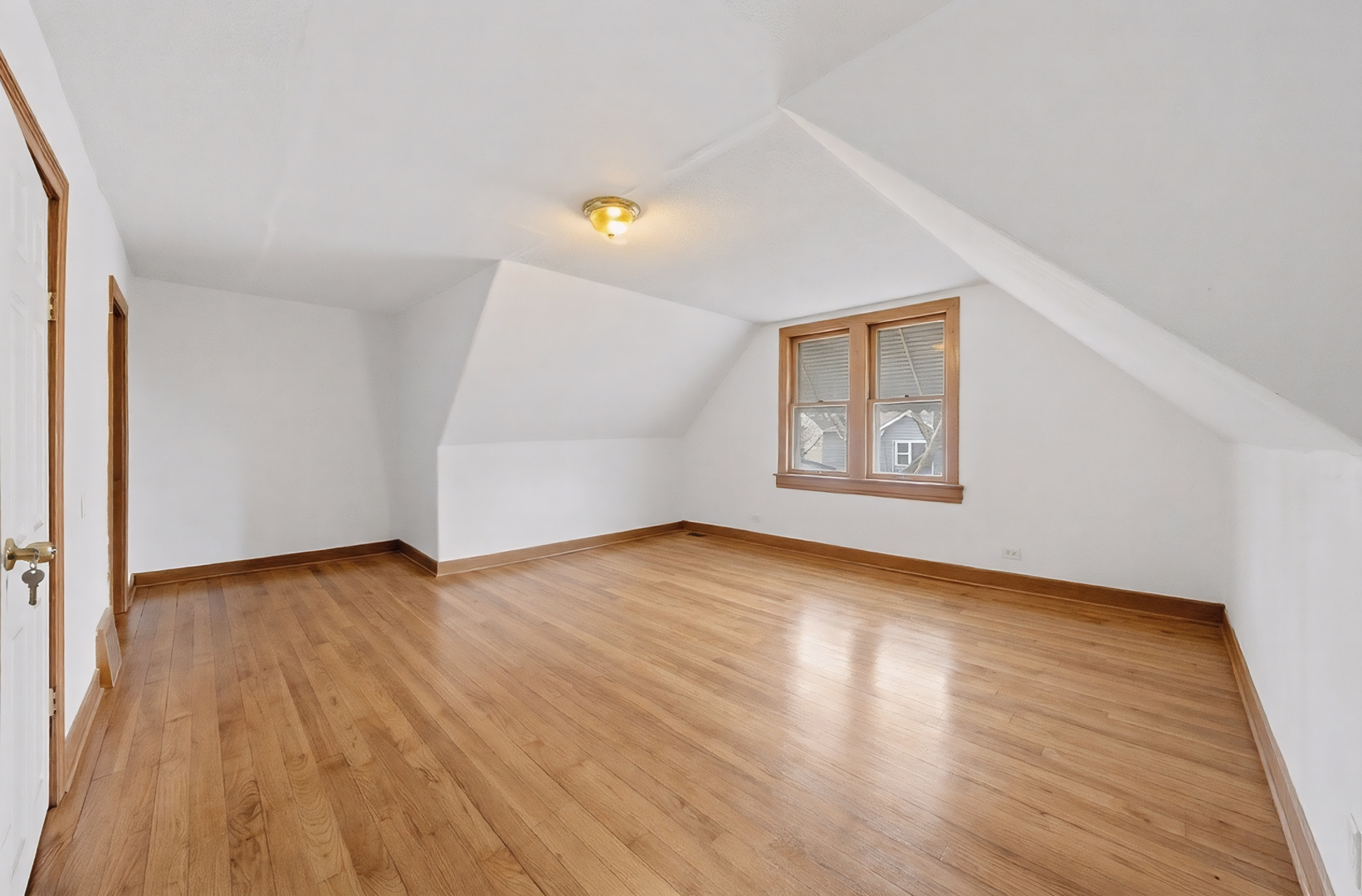 11735 South Indiana Avenue Chicago, IL 60628 - Photo 14 of 26 an empty room with wooden floor and windows