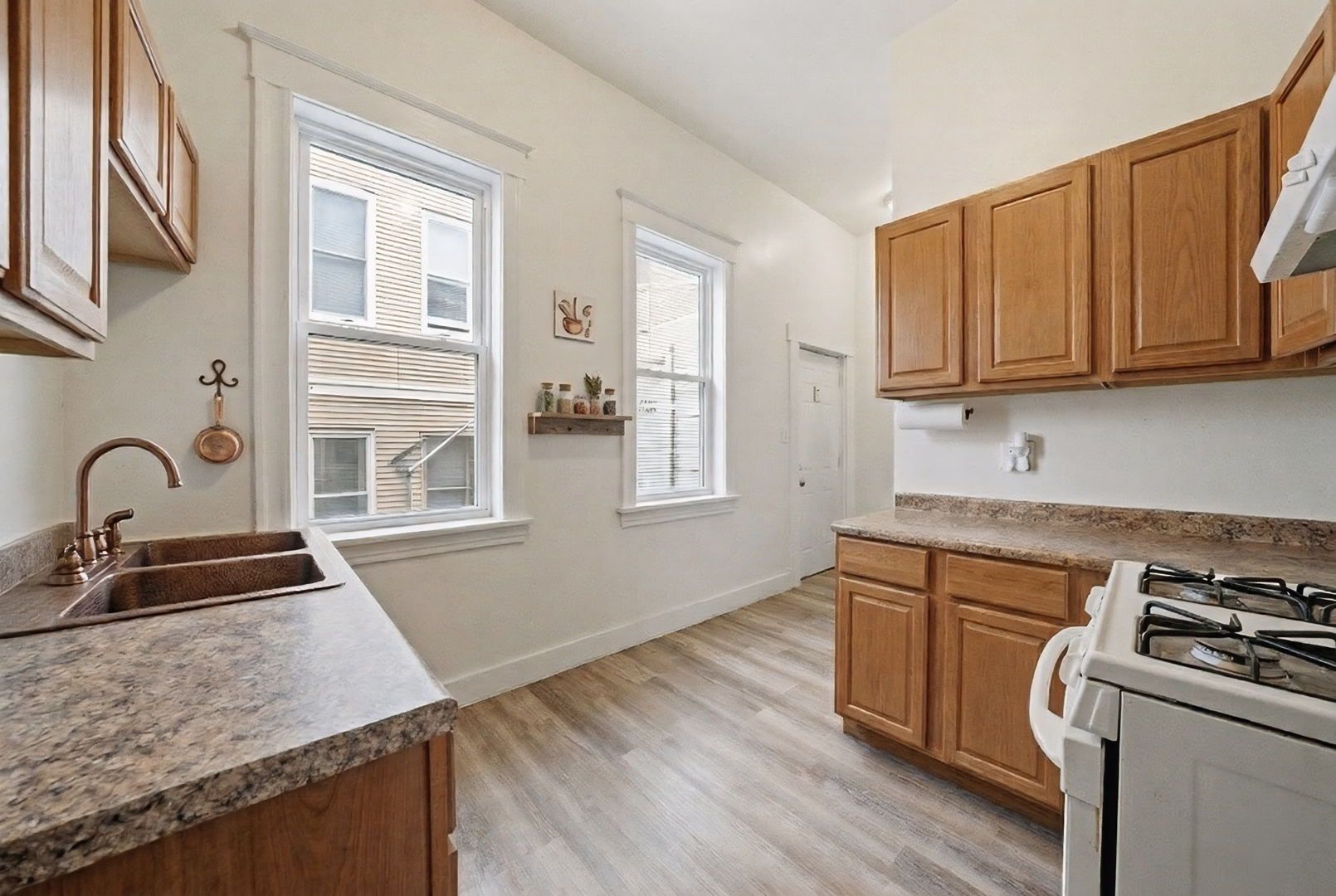 11735 South Indiana Avenue Chicago, IL 60628 - Photo 16 of 26 a kitchen that has a sink and a stove