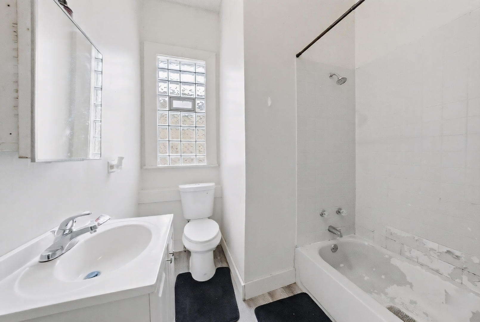 11735 South Indiana Avenue Chicago, IL 60628 - Photo 17 of 26 a bathroom with a sink and a bathtub