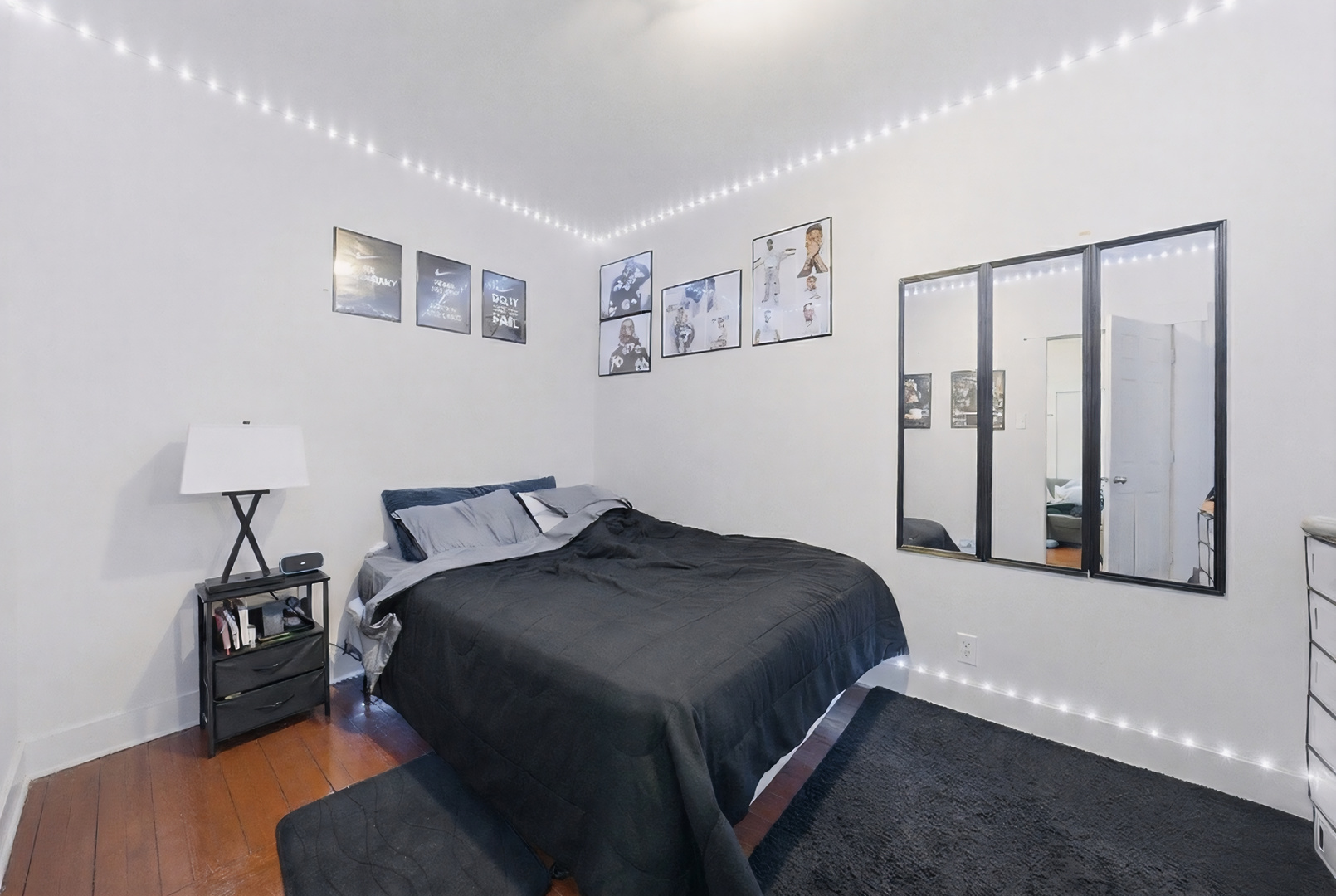 11735 South Indiana Avenue Chicago, IL 60628 - Photo 20 of 26 a bedroom with a bed and a lamp on table