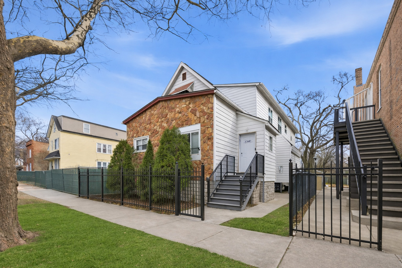 11735 South Indiana Avenue Chicago, IL 60628 - Photo 2 of 26 a view of a house with a yard and wooden fence