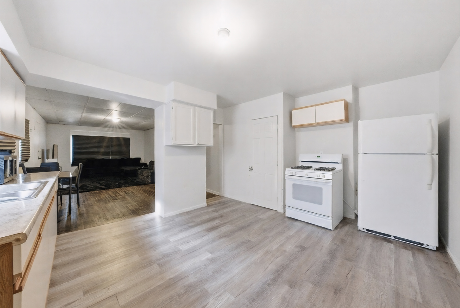 11735 South Indiana Avenue Chicago, IL 60628 - Photo 4 of 26 a view of a kitchen with a sink and a refrigerator