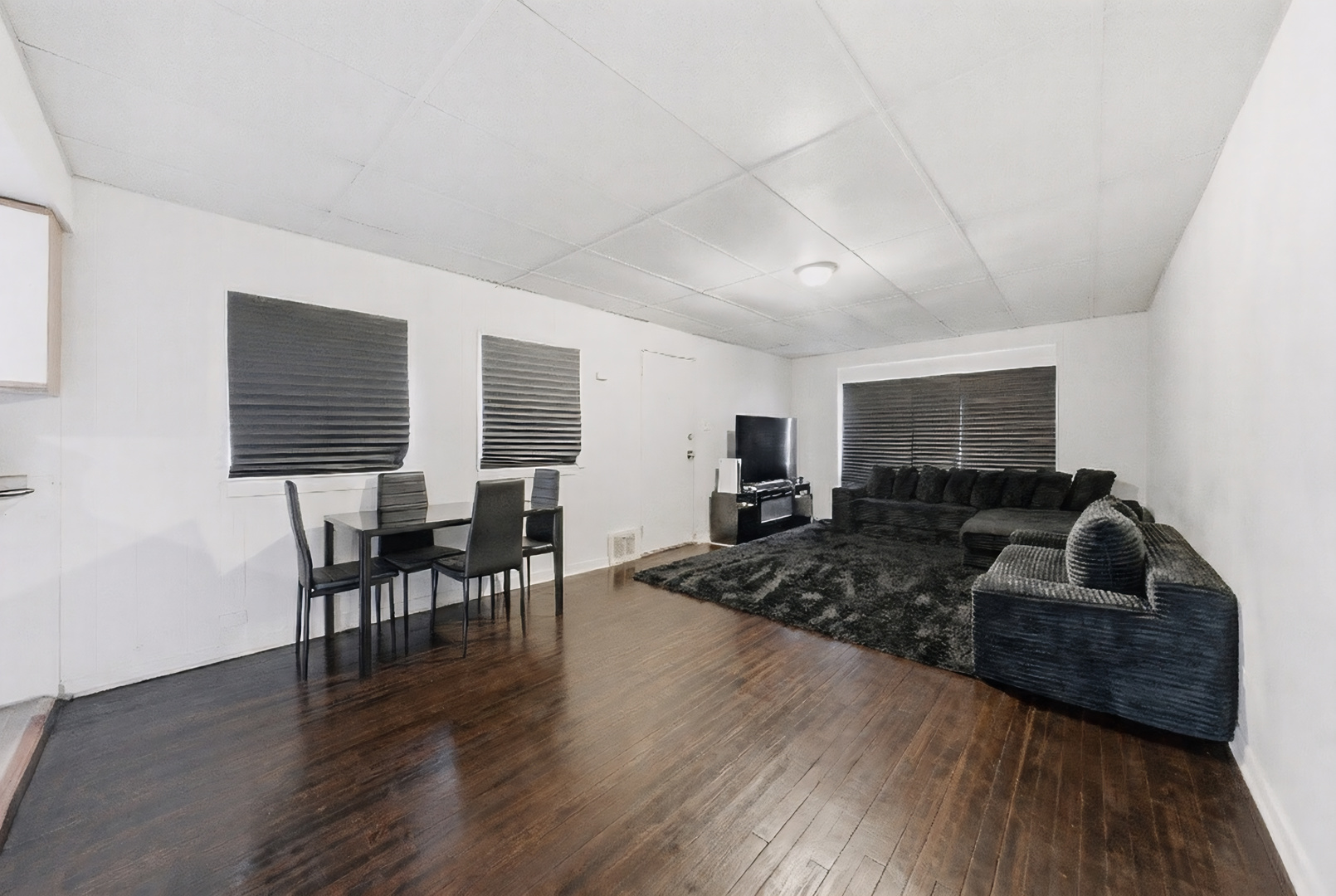 11735 South Indiana Avenue Chicago, IL 60628 - Photo 6 of 26 a living room with furniture wooden floor and a flat screen tv