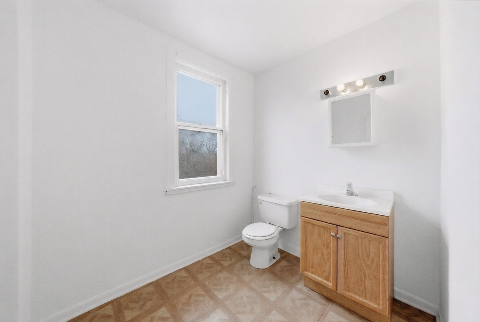 11735 South Indiana Avenue Chicago, IL 60628 - Photo 10 of 26 a bathroom with a toilet sink and mirror
