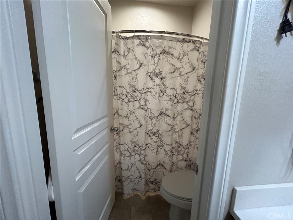 30099 Whembly Circle Menifee, CA 92584 - Photo 24 of 42 a bathroom with a shower and a toilet