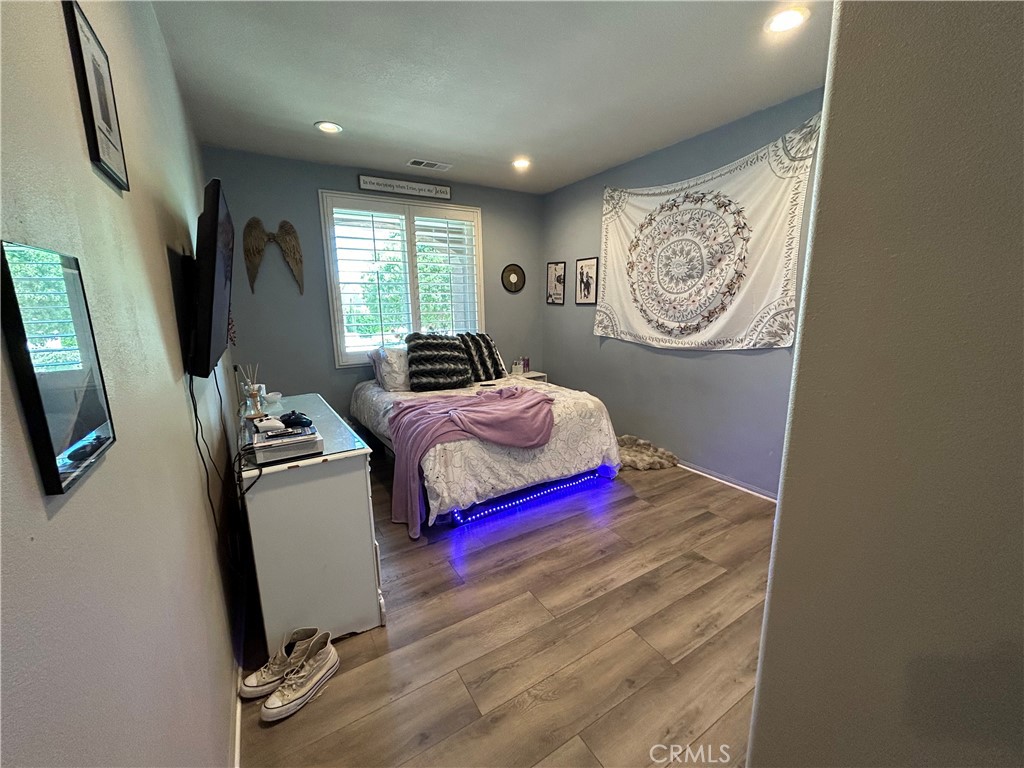 30099 Whembly Circle Menifee, CA 92584 - Photo 29 of 42 a bedroom with a bed and a flat screen tv