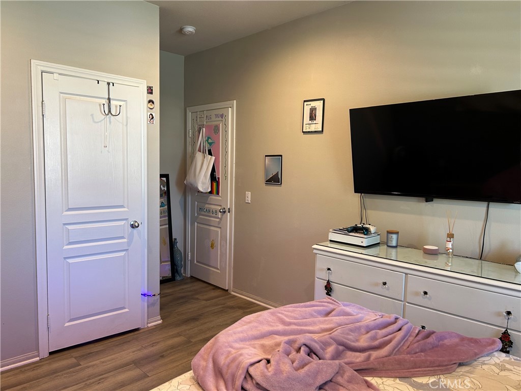 30099 Whembly Circle Menifee, CA 92584 - Photo 31 of 42 a bedroom with a bed and a flat screen tv