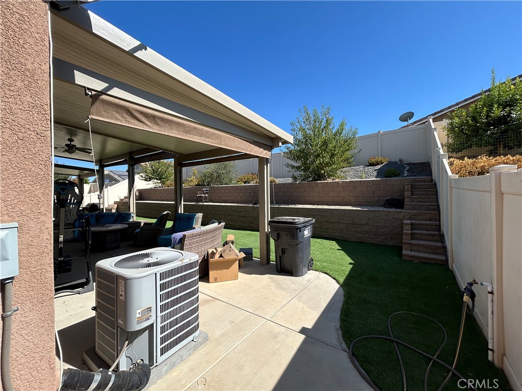 30099 Whembly Circle Menifee, CA 92584 - Photo 33 of 42 a view of a patio with table and chairs potted plants with sky view