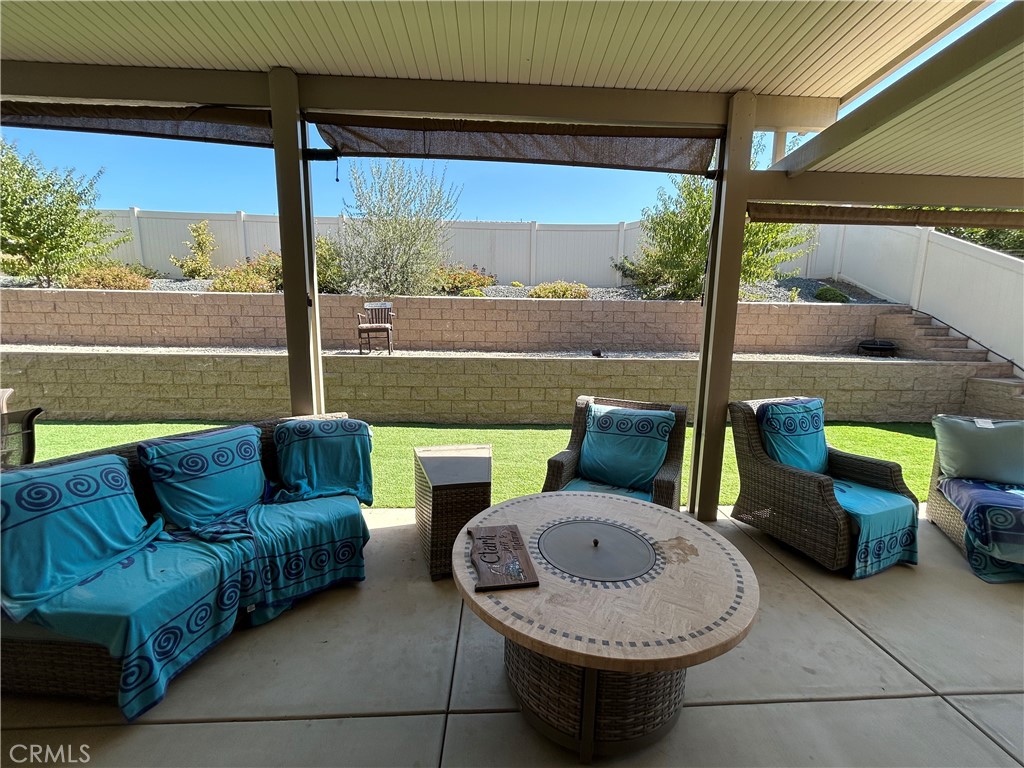 30099 Whembly Circle Menifee, CA 92584 - Photo 34 of 42 a living room with furniture and a floor to ceiling window