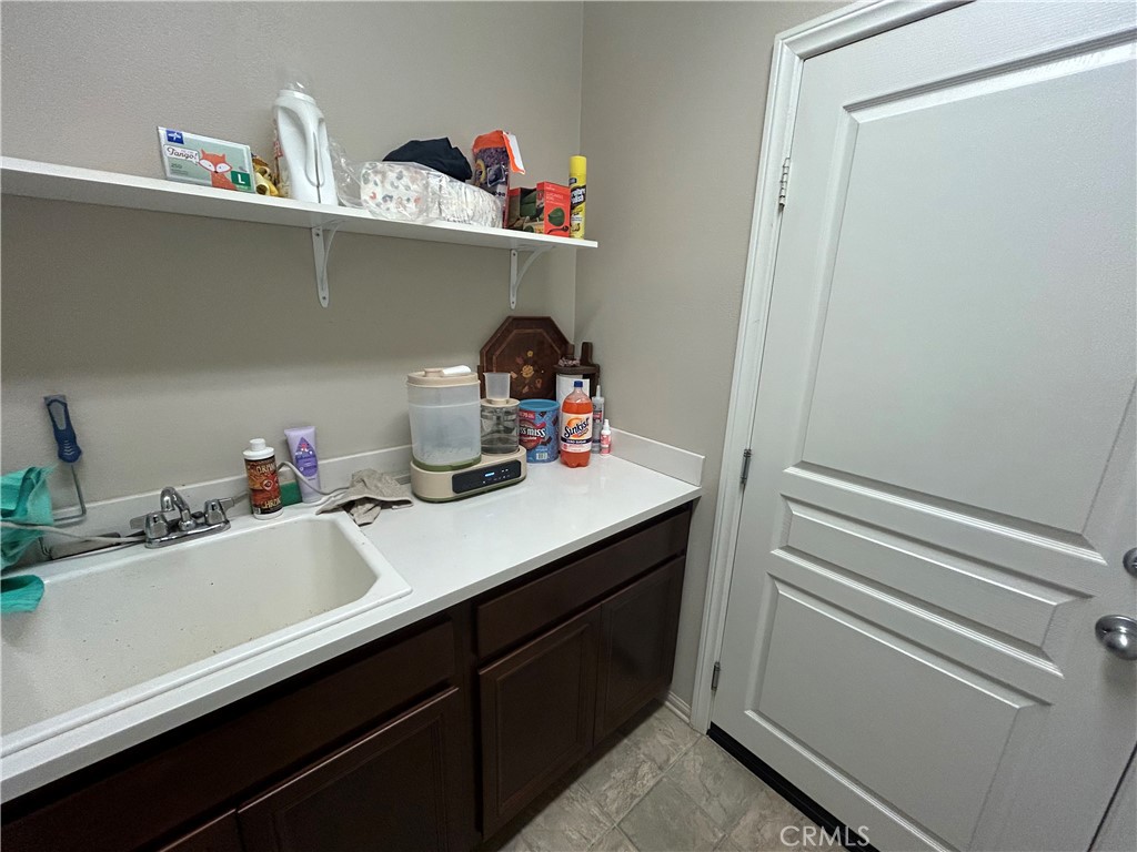 30099 Whembly Circle Menifee, CA 92584 - Photo 41 of 42 a kitchen with a sink and cabinets