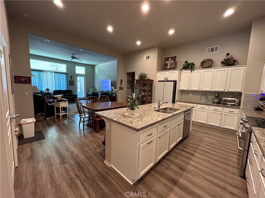 30099 Whembly Circle Menifee, CA 92584 - Photo 6 of 42 a kitchen with a stove and wooden floor