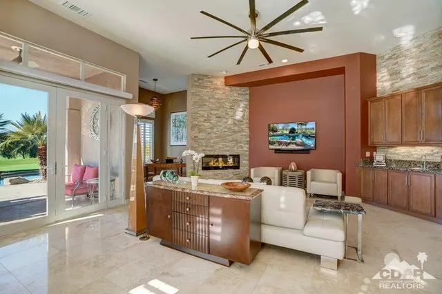 a living room with furniture a fireplace and a flat screen tv