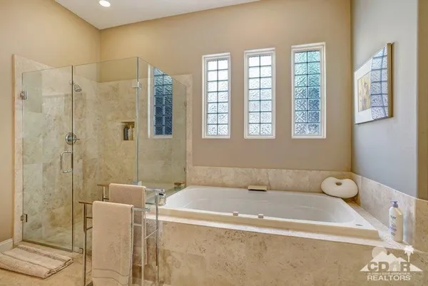 a bath tub sitting next to a bathroom and sink
