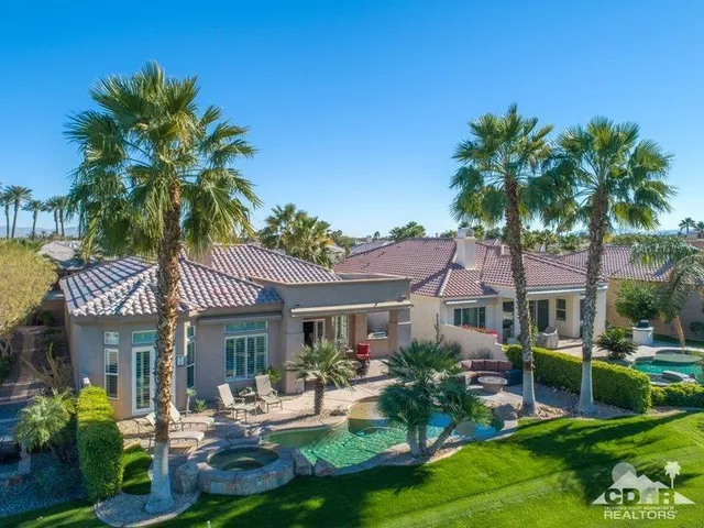 a front view of a house with garden and porch