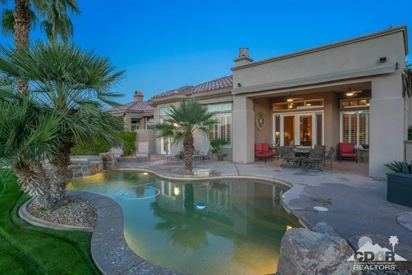 a view of a swimming pool with sitting area