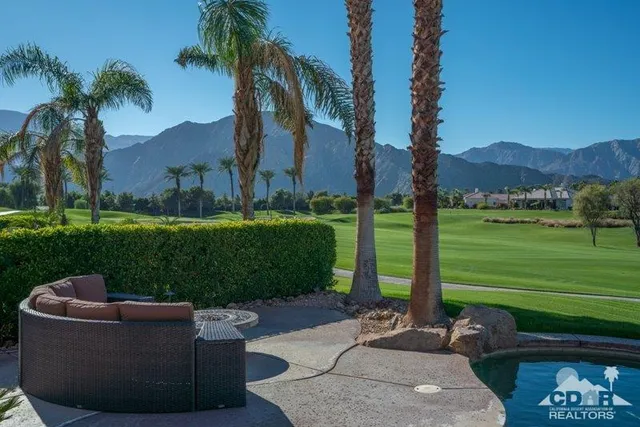 a view of a patio with a table and chairs
