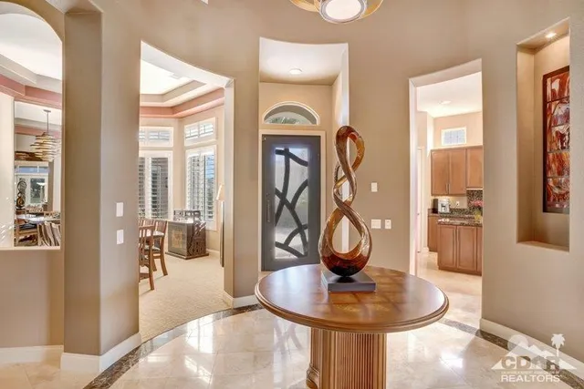a dining room with wooden floor a glass table and chairs