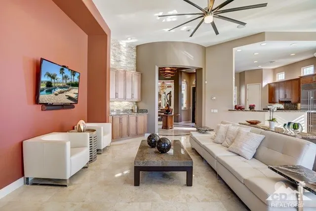 a living room with furniture and a ceiling fan